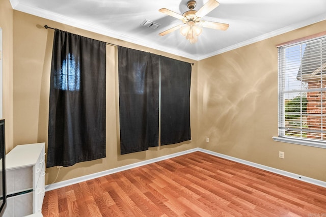 unfurnished room featuring plenty of natural light, ceiling fan, ornamental molding, and light hardwood / wood-style flooring