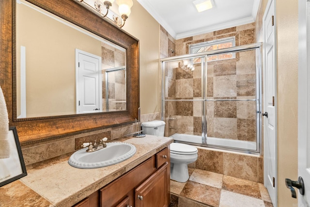 full bathroom featuring shower / bath combination with glass door, crown molding, vanity, and toilet