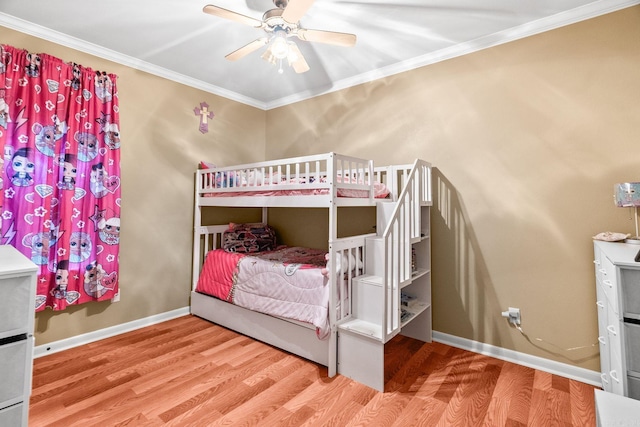 bedroom with hardwood / wood-style flooring, ceiling fan, and crown molding