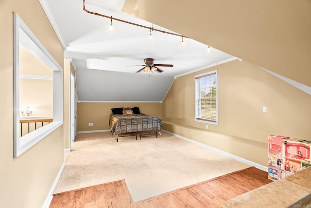 bedroom featuring crown molding, ceiling fan, lofted ceiling, and hardwood / wood-style flooring