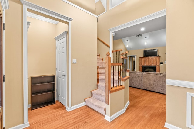 stairs featuring vaulted ceiling and hardwood / wood-style flooring