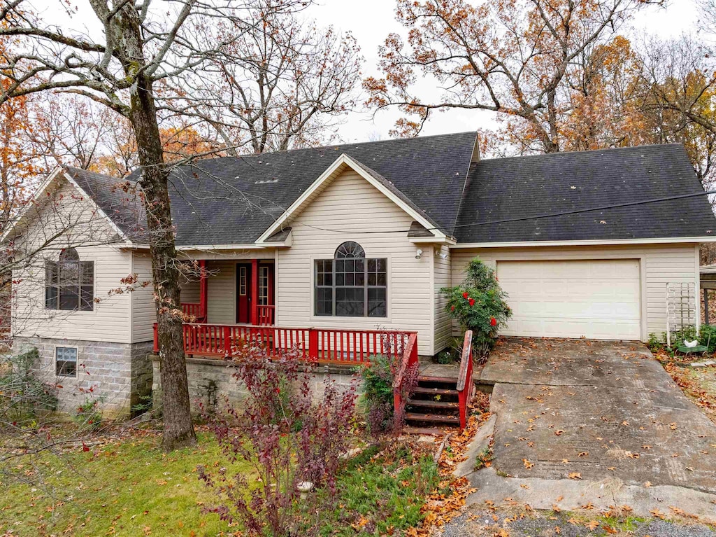 ranch-style house with covered porch and a garage