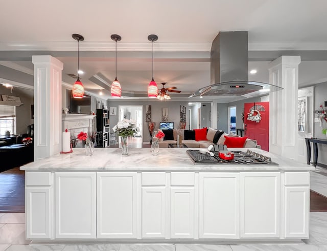 kitchen with island range hood, white cabinetry, hanging light fixtures, and ceiling fan