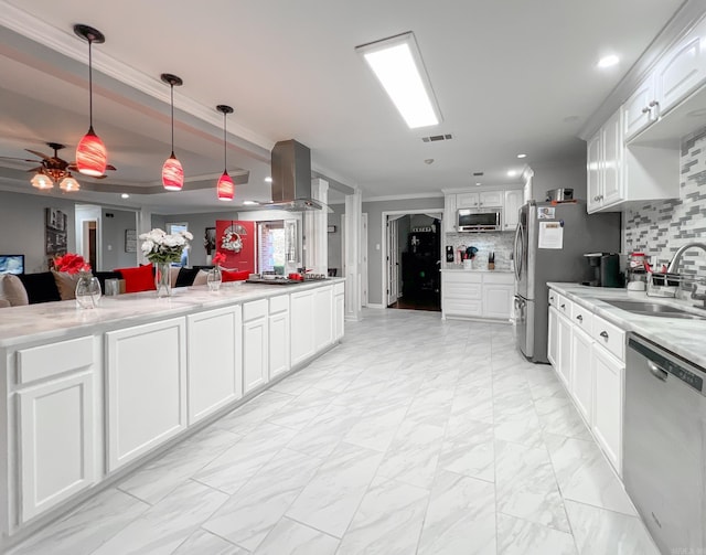 kitchen featuring sink, hanging light fixtures, decorative backsplash, white cabinets, and appliances with stainless steel finishes