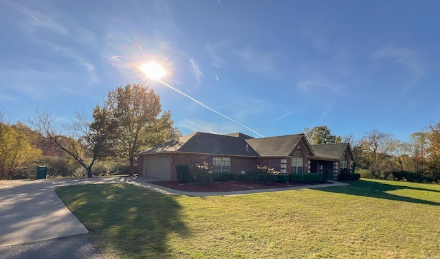 view of front of property featuring a garage and a front lawn