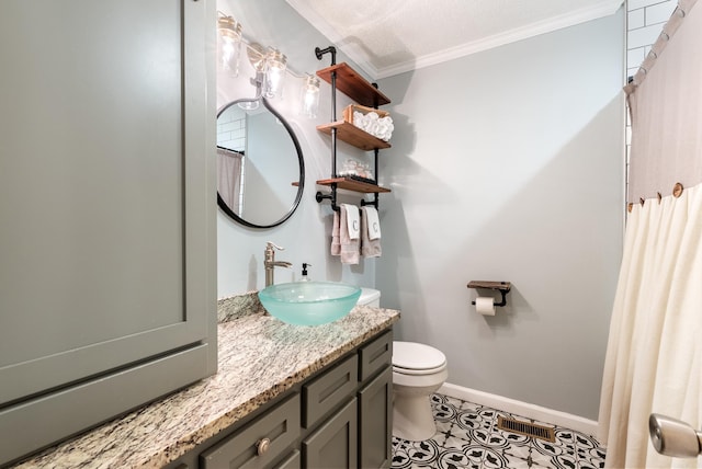 bathroom featuring a textured ceiling, vanity, crown molding, tile patterned flooring, and toilet