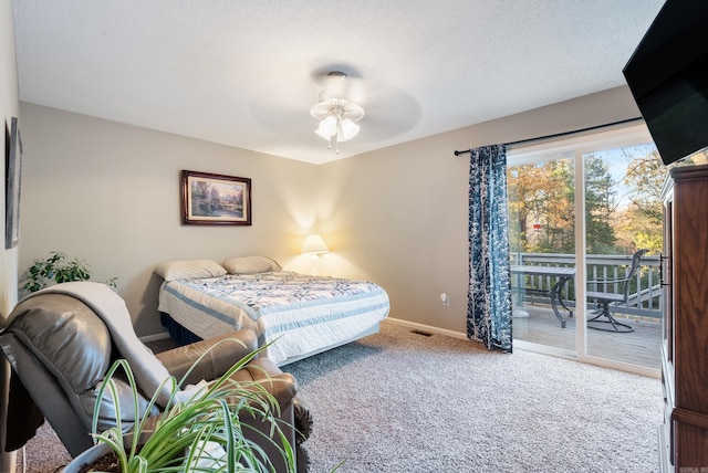 carpeted bedroom with ceiling fan, a textured ceiling, and access to outside