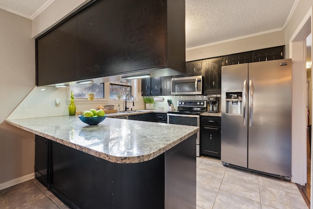 kitchen featuring kitchen peninsula, a textured ceiling, and appliances with stainless steel finishes