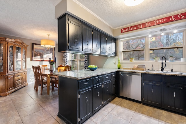 kitchen featuring a wealth of natural light, a textured ceiling, crown molding, sink, and dishwasher