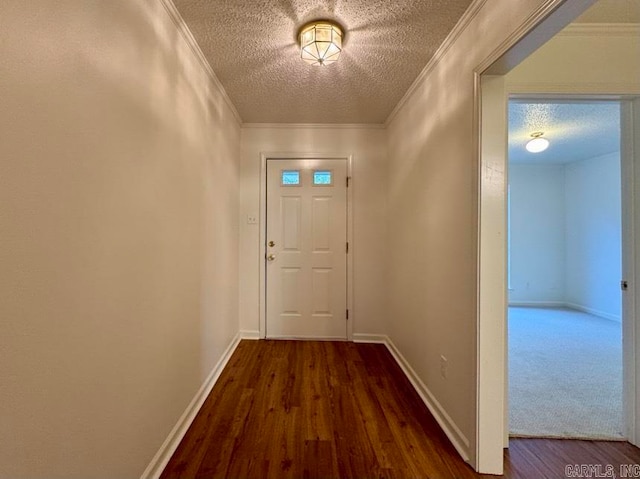 doorway featuring crown molding, dark hardwood / wood-style flooring, and a textured ceiling