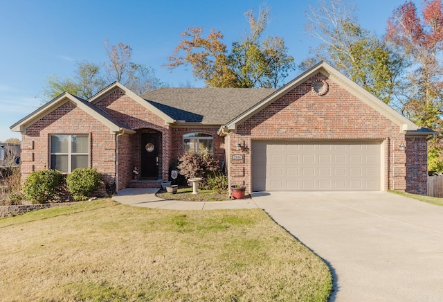 single story home featuring a garage and a front lawn