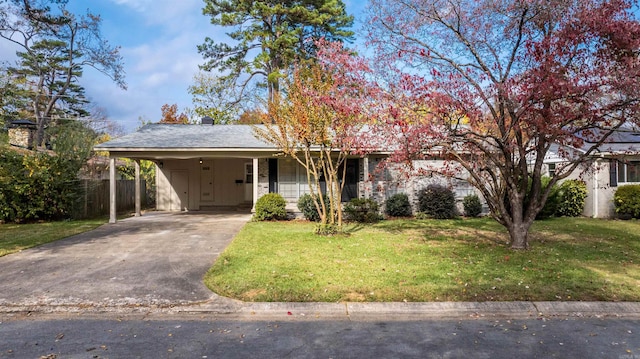 view of front of house with a front lawn and a carport