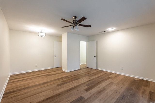 unfurnished room featuring hardwood / wood-style floors and ceiling fan