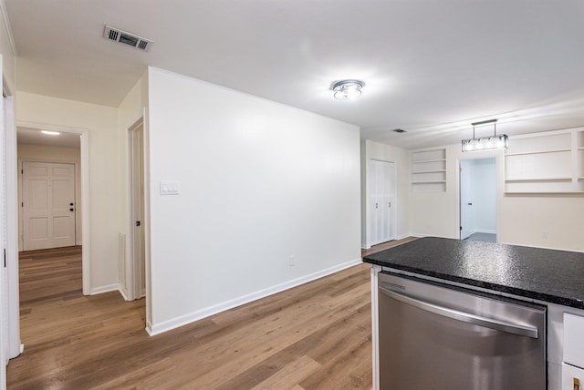 kitchen with dishwasher, pendant lighting, light wood-type flooring, and white cabinetry