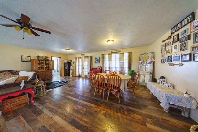 dining room featuring ceiling fan, dark hardwood / wood-style flooring, and a textured ceiling