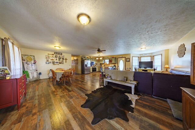 living room featuring a textured ceiling, dark hardwood / wood-style floors, and ceiling fan