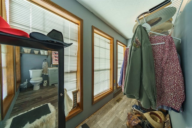 bathroom featuring hardwood / wood-style flooring and toilet