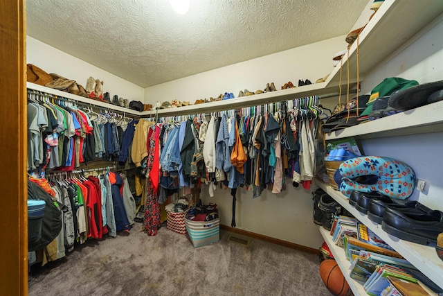 walk in closet featuring carpet floors