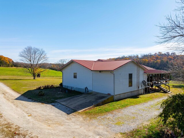 view of side of home with a lawn