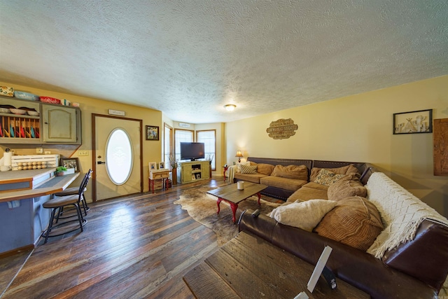 living room featuring a textured ceiling and dark wood-type flooring