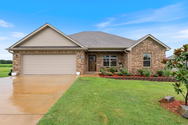 view of front of home with a front lawn and a garage