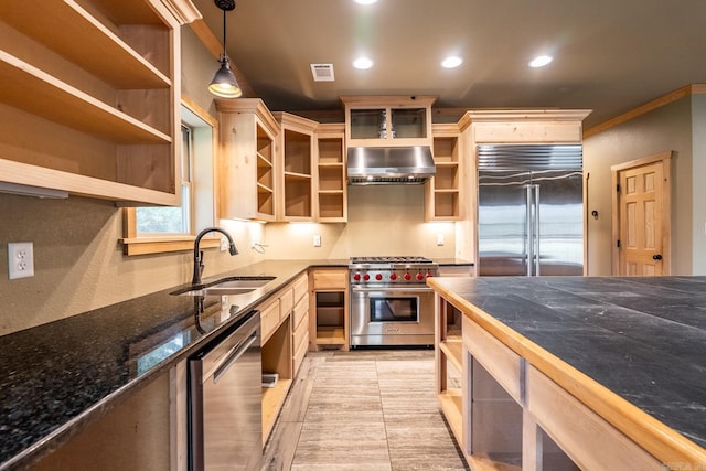 kitchen featuring premium appliances, sink, exhaust hood, pendant lighting, and light tile patterned flooring