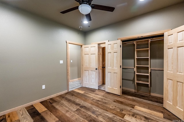 unfurnished bedroom with hardwood / wood-style floors, ceiling fan, and a closet