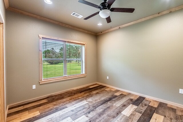 spare room with ceiling fan, ornamental molding, and hardwood / wood-style flooring