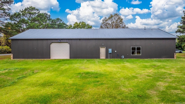 exterior space with a garage, an outdoor structure, and a yard