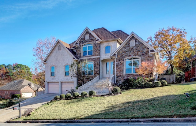 view of property with a garage and a front yard