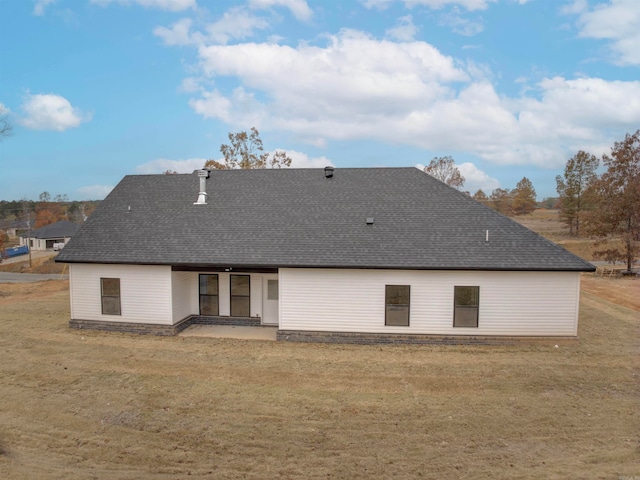 rear view of house featuring a yard and a patio area