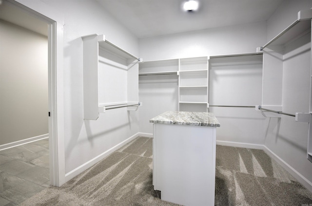 walk in closet featuring dark colored carpet