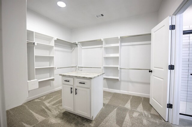 spacious closet featuring light carpet