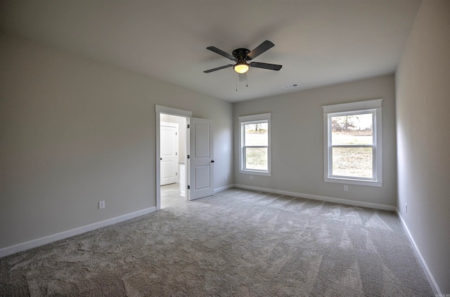 spare room with light carpet and ceiling fan