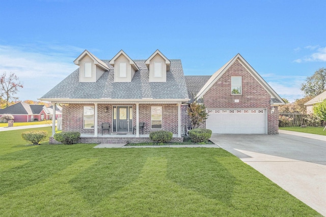 cape cod-style house featuring covered porch, a garage, and a front yard