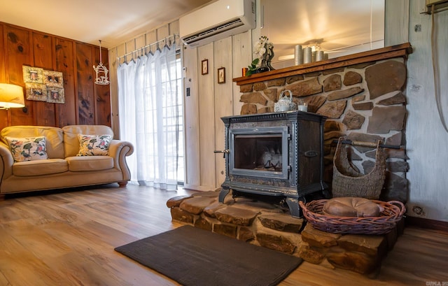 living room with wood walls, light wood-type flooring, a wealth of natural light, and a wall mounted AC