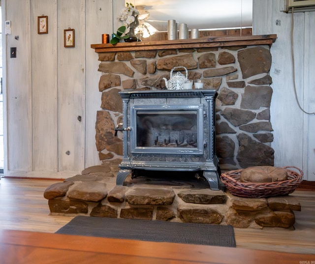 details with hardwood / wood-style flooring and a wood stove