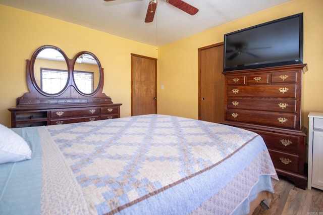 bedroom with ceiling fan and hardwood / wood-style flooring