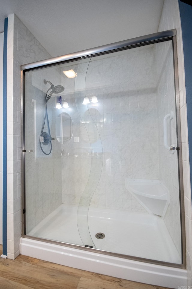 bathroom featuring hardwood / wood-style floors and walk in shower