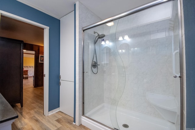 bathroom featuring wood-type flooring and a shower with door