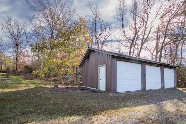 garage featuring a lawn