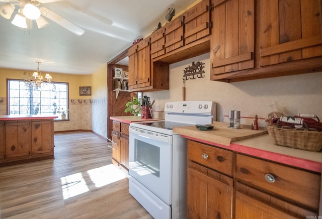 kitchen featuring electric range, decorative light fixtures, light hardwood / wood-style floors, and ceiling fan with notable chandelier