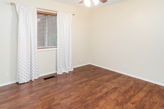 empty room featuring ceiling fan and dark wood-type flooring