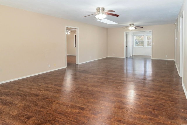 unfurnished room featuring ceiling fan and dark wood-type flooring