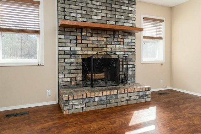 details featuring wood-type flooring and a brick fireplace