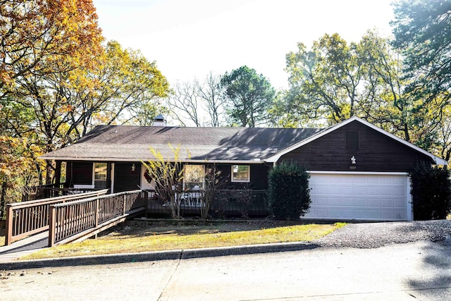 ranch-style home featuring a garage and covered porch