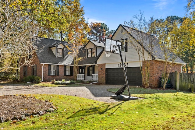 view of front facade with a front lawn, covered porch, and a garage