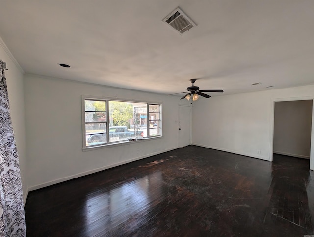 empty room with ceiling fan and dark wood-type flooring