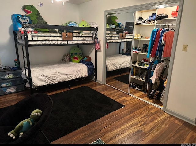 bedroom with hardwood / wood-style floors and a closet