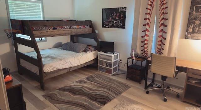 bedroom with hardwood / wood-style floors